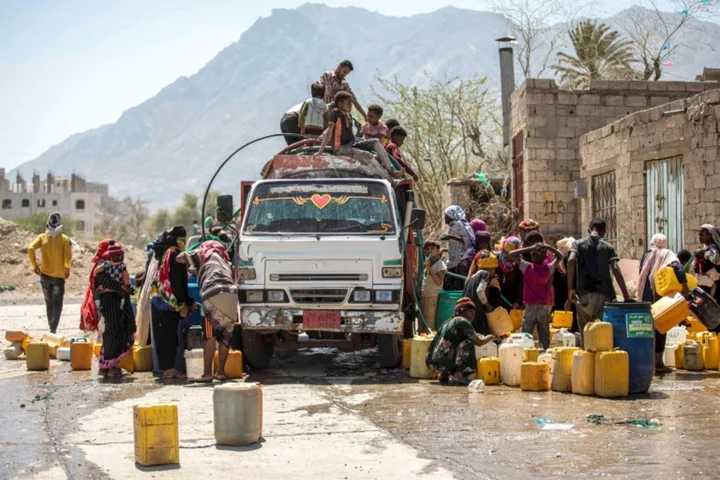 Children in war-scarred Yemen line up for water, not school