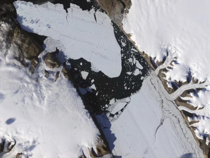 Warming-stoked tides eating huge holes in Greenland glacier