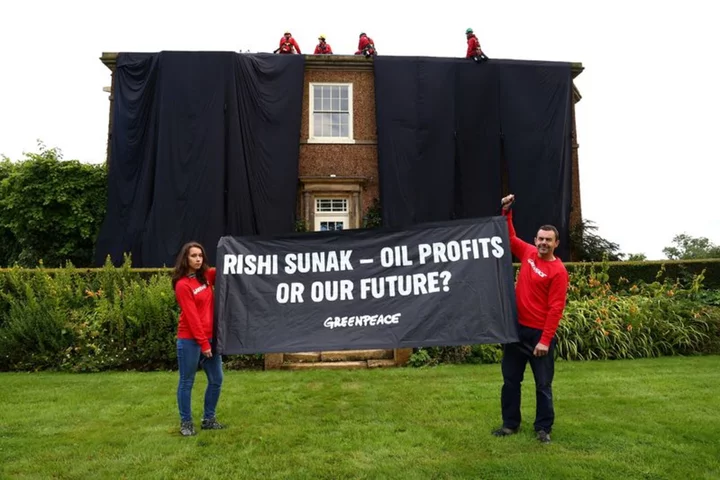 Greenpeace oil protesters cover Rishi Sunak's home in black fabric