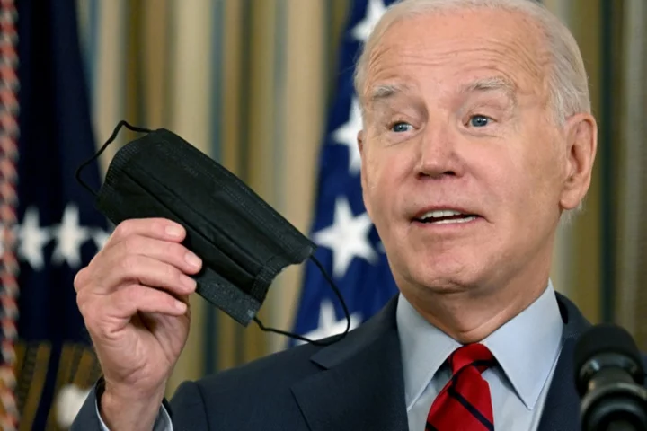 Maskless Biden laughs off Covid guidance