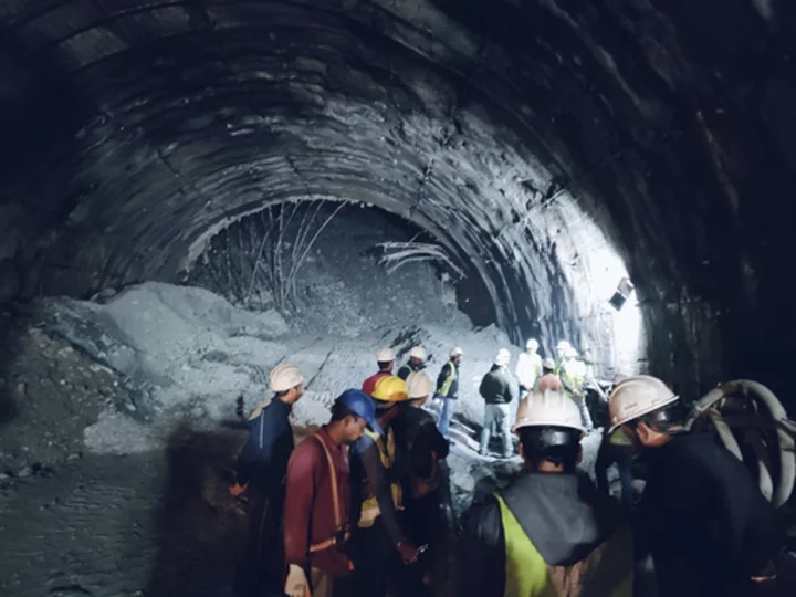 Rescuers dig to reach 40 workers trapped in collapsed road tunnel in north India