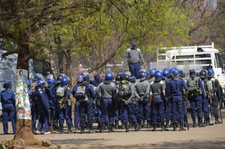 Zimbabweans anxiously wait for election results as armed police gather with water cannons