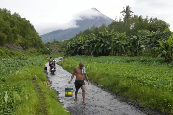 Rains unleashed by typhoon worry thousands of people fleeing restive Philippine volcano