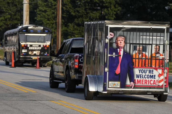 Scores of Trump supporters show support outside Georgia jail ahead of his expected surrender