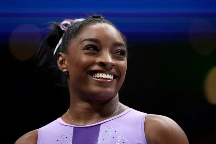 Biles leads US gymnastics championships at halfway stage