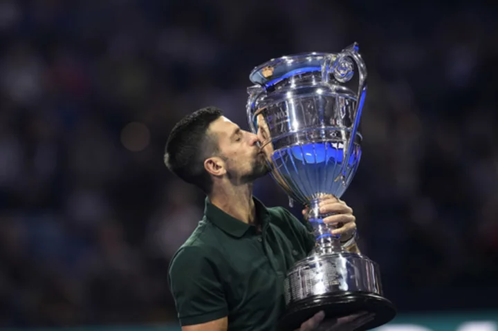 Novak Djokovic gets his trophy after securing year-end No. 1 ranking for a record-extending 8th time