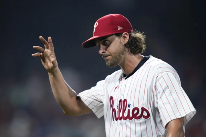 Nola, Schwarber help the Phillies beat the Brewers 4-3 for their 4th straight victory