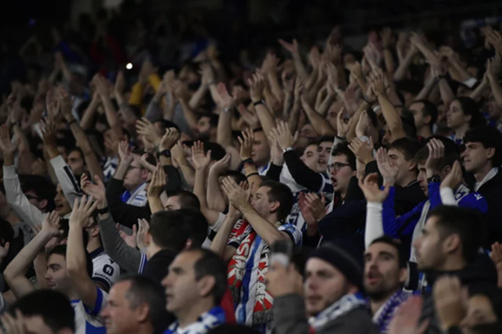 Benfica fans throw flares toward Sociedad supporters at Champions League match