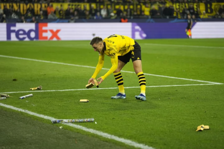 Borussia Dortmund fans throw fake money to protest UEFA's planned Champions League reforms