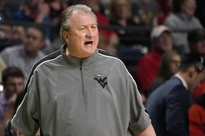 West Virginia's Huggins agrees to pay cut, suspension for homophobic slur, AP source says