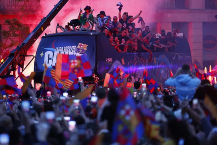 Nearly 80,000 celebrate Barcelona in victory parade for men's and women's teams