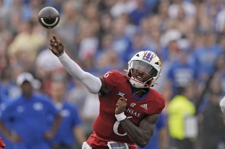 Daniels throws 3 TD passes, KU gets 2 defensive scores to beat BYU 38-27 in its Big 12 debut