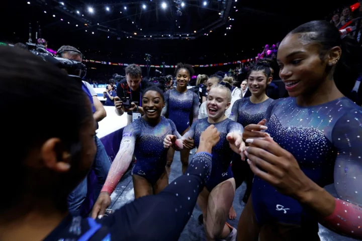 Biles wins 20th world title as US women seal team gold