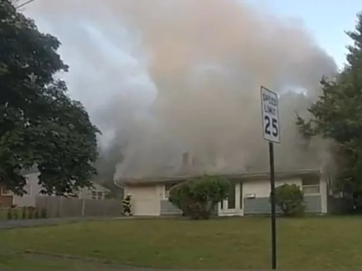 An 85-year-old man and a passerby detected a fire at a New Jersey home and teamed up to wake the sleeping family inside