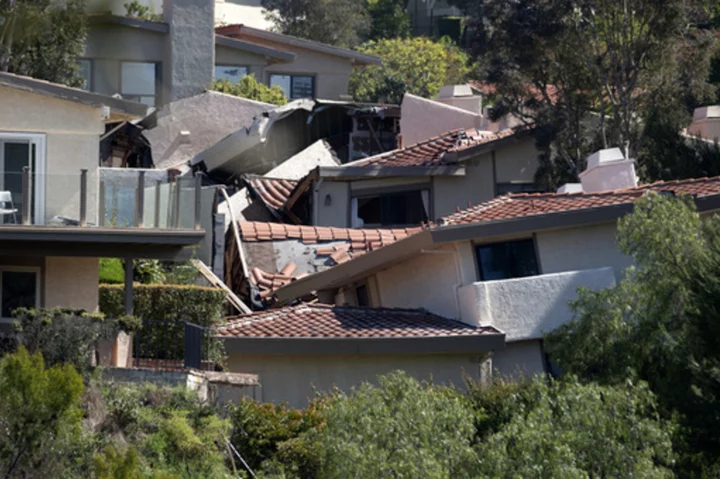 Destructive Southern California landslide slows but more homes ordered evacuated as sewer breaks