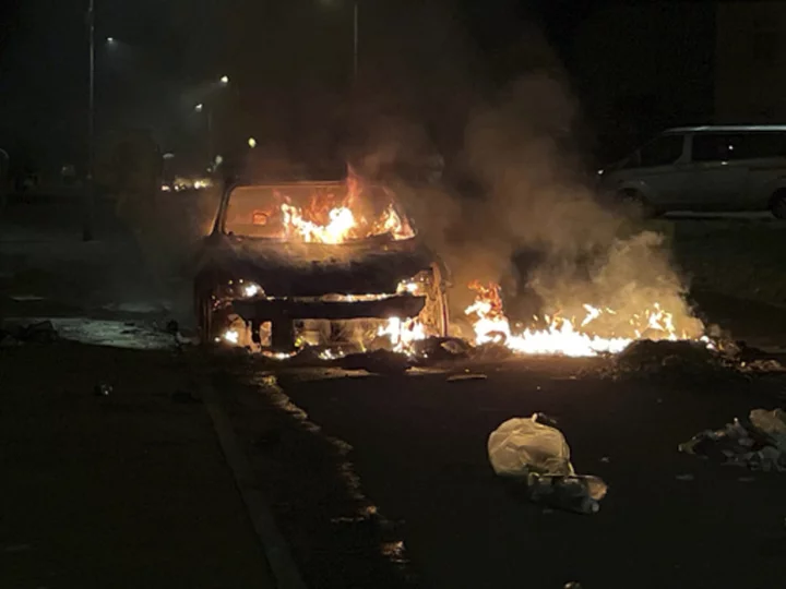 Cars set on fire in Cardiff as UK police face 'large scale disorder' after road crash